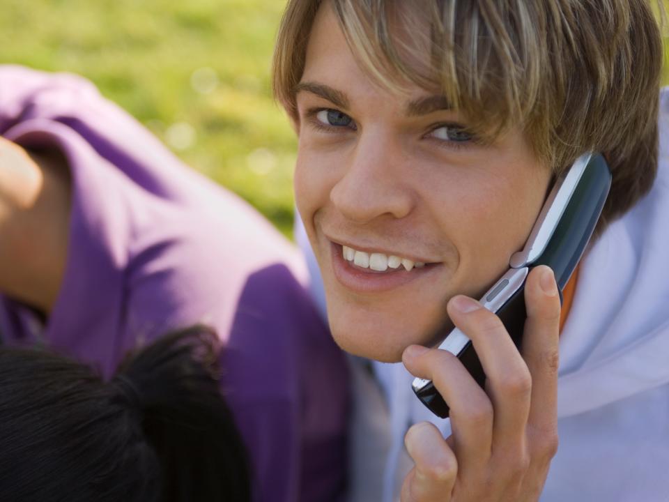 young man using flip phone