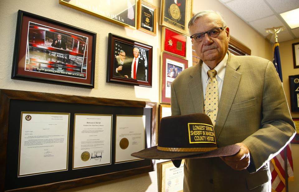 FILE - In this Aug. 26, 2019, file photo standing next to his presidential pardon from President Donald Trump, former Arizona Maricopa County Sheriff Joe Arpaio poses for a photograph as he announces his 2020 campaign for Maricopa County Sheriff in Fountain Hills, Ariz. Arpaio's primary defeat in his bid to win back the sheriff's post in metro Phoenix marks what's likely to be the 88-year-old's last political campaign. (AP Photo/Ross D. Franklin, File)