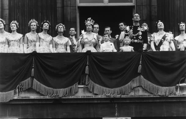 PHOTO: The newly crowned Queen Elizabeth II waves to the crowd from the balcony at Buckingham Palace following her Coronation, June 2, 1953, in London. (Fox Photos/Getty Images)