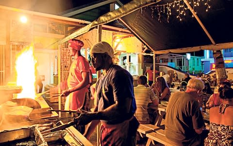 Most people visit Oistins for the lively Fish Fry party on Friday - Credit: Alamy