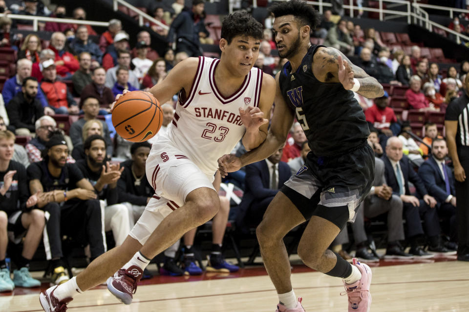 Stanford forward Brandon Angel (23) drives past Washington guard Jamal Bey during the first half of an NCAA college basketball game in Stanford, Calif., Sunday, Feb. 26, 2023. (AP Photo/John Hefti)