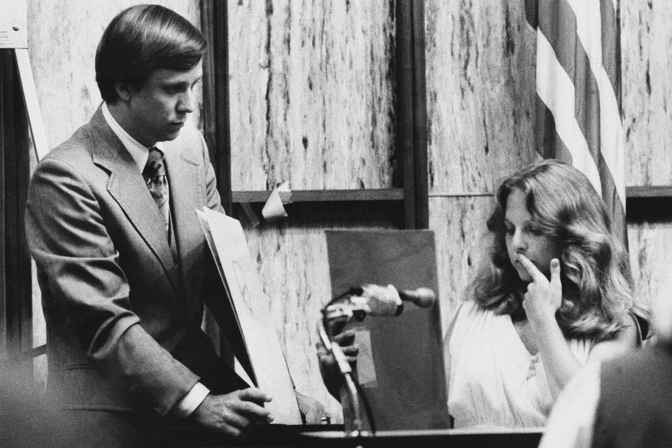 FILE - In this July 18, 1979 file photo, Nita Jane Neary, right, looks at drawing in court as prosecution attorney Larry Simpson holds additional prints during the murder trial of Ted Bundy in Miami, Fla. Neary is considered a key witness as she is the only eyewitness in the trial. (AP Photo/Pool)