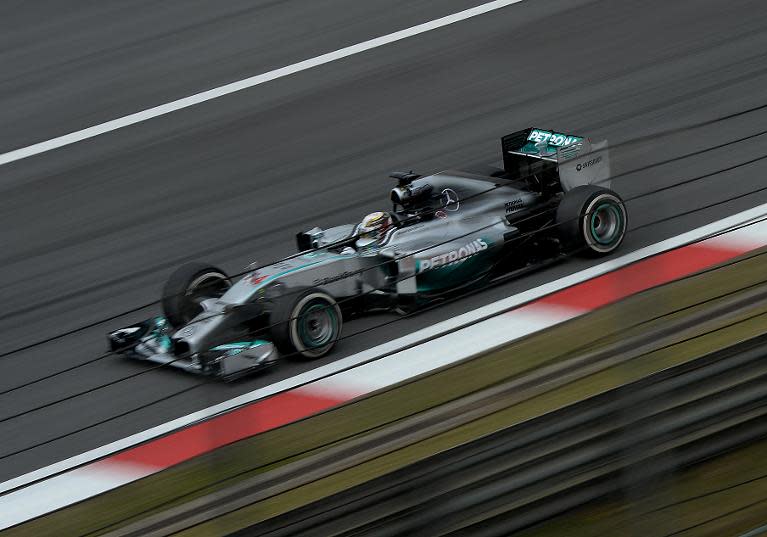 Lewis Hamilton powers his car on the main straight before finishing with the fastest time during the second practice session of the Formula One Chinese Grand Prix in Shanghai on April 18, 2014