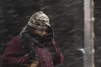 <p>A woman shields her face during a winter storm in Philadelphia, Thursday, Feb. 9, 2017. A powerful, fast-moving storm swept through the northeastern U.S. Thursday, making for a slippery morning commute and leaving some residents bracing for blizzard conditions. (Photo: Matt Rourke/AP) </p>