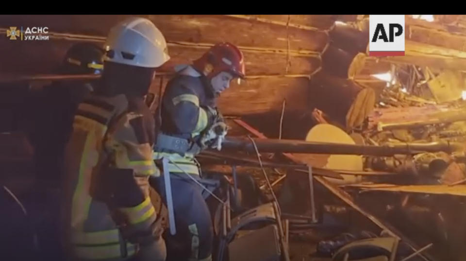 In this image made from video, a firefighter holds a kitten after rescuing it from a burning building in Kharkiv, Ukraine, Sunday, Sept. 4, 2022. Ukraine’s emergency services posted video to Facebook on Sunday showing the firefighters petting and cuddling the kitten as they carried it to safety. One said, “We found a beauty." Ukraine’s emergency services said the kitten’s paw needed medical attention. (State Emergency Service of Ukraine via AP)