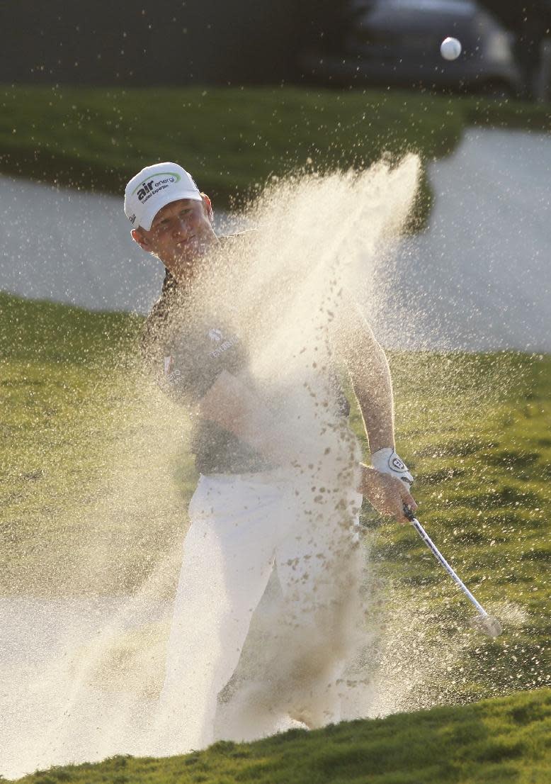 Jamie Donaldson, of Wales, hits from a 18th hole sand trap during the final round of the Cadillac Championship golf tournament on Sunday, March 9, 2014, in Doral, Fla. (AP Photo/Marta Lavandier)