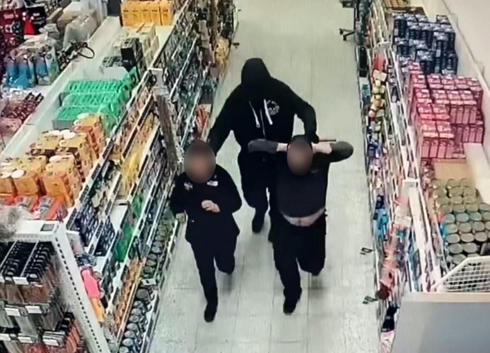 Two men who threatened shop workers with an axe during an armed robbery have been jailed (swns)