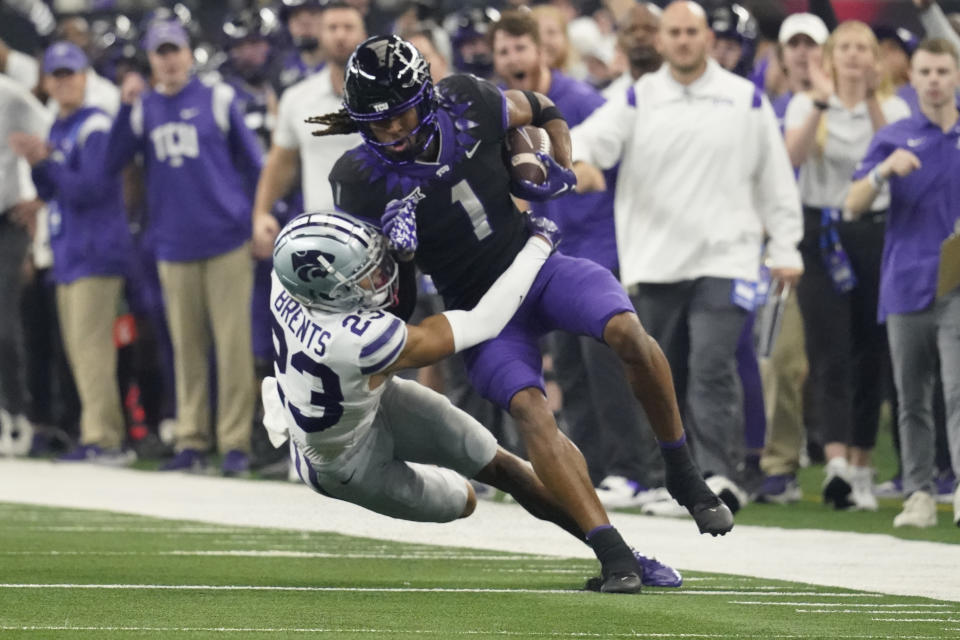 TCU wide receiver Quentin Johnston (1) is tackled by Kansas State cornerback Julius Brents (23) in the first half of the Big 12 Conference championship NCAA college football game, Saturday, Dec. 3, 2022, in Arlington, Texas. (AP Photo/LM Otero)