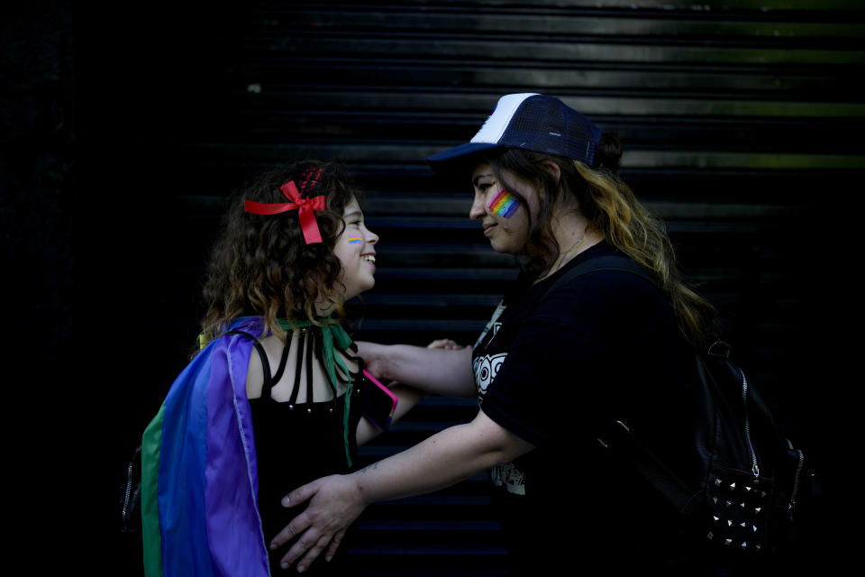 Micaela Amorena and her trans daughter Elizabeth pose for a photo during a Pride March in Buenos Aires Argentina, Saturday, Nov. 5, 2022. Amorena is a member of a group of mothers of LGBTQ children that was created to unite women across Latin America and help them push back against the enduring discrimination that sexual minorities continue to experience across much of the region. (AP Photo/Natacha Pisarenko)