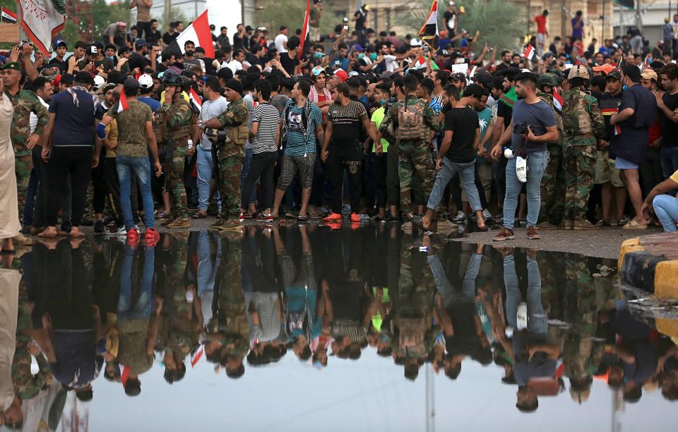 Anti-government protesters gather near Basra provincial council building during a demonstration in Basra, Iraq, Monday, Oct. 28, 2019. (AP Photo/Nabil al-Jurani)