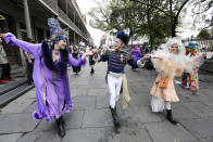 Dayna Kurtz, Robert Mache, and Ali Duffey dance in the French Quarter on Mardi Gras day in New Orleans, Tuesday, Feb. 25, 2020. (AP Photo/Rusty Costanza)