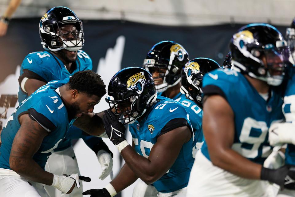 Jacksonville Jaguars linebacker Josh Allen (41) congratulates linebacker Yasir Abdullah (56) for his interception during the second quarter of a preseason matchup Saturday, Aug. 26, 2023 at EverBank Stadium in Jacksonville, Fla. The game was suspended in the fourth after Miami Dolphins wide receiver Daewood Davis (87) was injured on a play with the Jaguars leading 31-18.