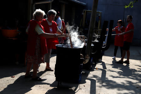 Elderly women cook plum marmalade in Bordany, Hungary, September 19, 2018. REUTERS/Bernadett Szabo