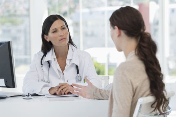 Female doctor discussing with a patient