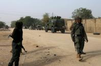 FILE PHOTO: Nigerian military secure the area where a man was killed by suspected militants during an attack around Polo area of Maiduguri