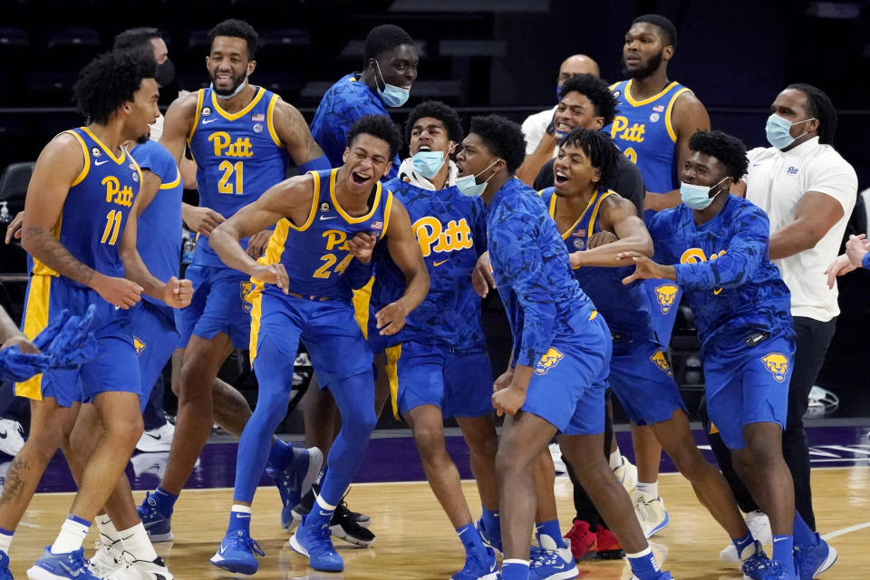 Pittsburgh's Justin Champagnie, left, celebrates with teammates after Pittsburgh win over Northwestern in an NCAA college basketball game in Evanston, Ill., Wednesday, Dec. 9, 2020. (AP Photo/Nam Y. Huh)