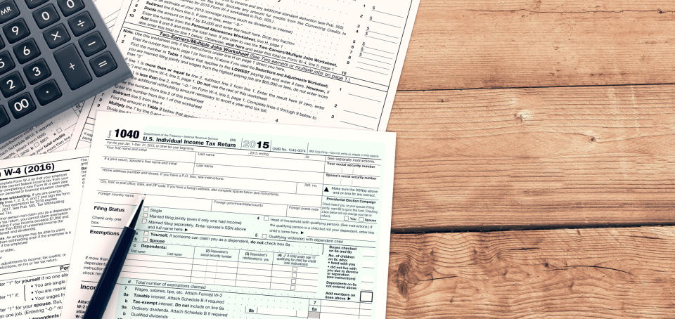 Pen and calculator resting on tax forms