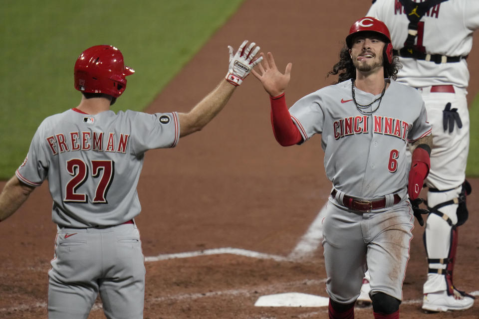 Cincinnati Reds' Jonathan India (6) is congratulated by teammate Mike Freeman (27) after scoring during the sixth inning of a baseball game against the St. Louis Cardinals Friday, June 4, 2021, in St. Louis. (AP Photo/Jeff Roberson)