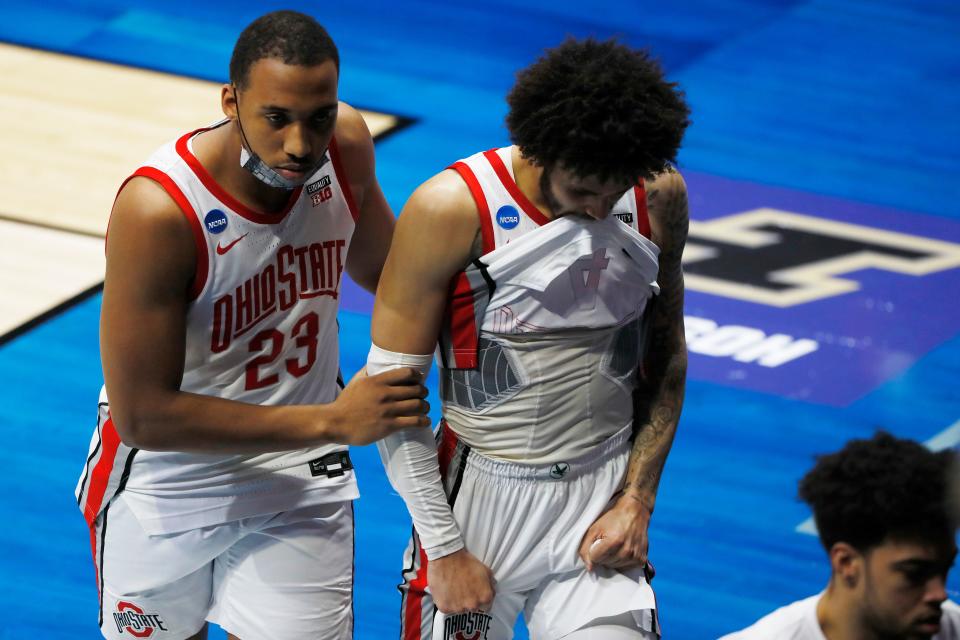 Mar 19, 2021; West Lafayette, Indiana, USA; Ohio State Buckeyes forward Zed Key (23) and guard Duane Washington Jr. (4) react as they leave the court after overtime loss to the Oral Roberts Golden Eagles in the first round of the 2021 NCAA Tournament at Mackey Arena. Mandatory Credit: Joshua Bickel-USA TODAY Sports