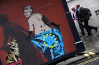 <p>Workers walk near street art depicting Britain’s Queen Elizabeth with a pet dog, holding an EU flag in London, Britain, April 24, 2017. (Toby Melville/Reuters) </p>