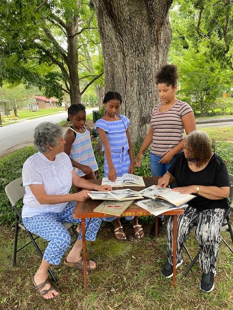 Black History Committee members Suzanne Hale (left) and Shirley Davidson (right) meeting with, from left to right, Maliyah Frady, Aniyah Frady and Ry-Lei Young.