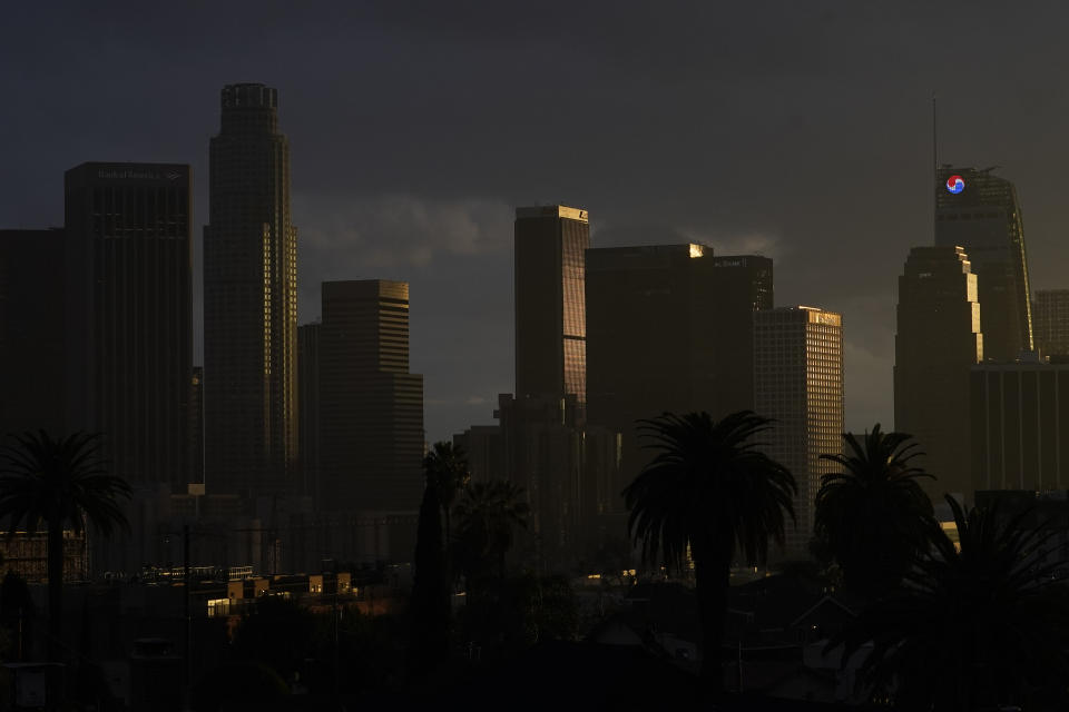 Heavy clouds move over downtown Los Angeles, Monday, Dec. 13, 2021. The storm will bring much-needed moisture to the broader region that's been gripped by drought that scientists have said is caused by climate change. The latest U.S. drought monitor shows parts of Montana, Oregon, California, Nevada and Utah are classified as being in exceptional drought, which is the worst category. (AP Photo/Damian Dovarganes)