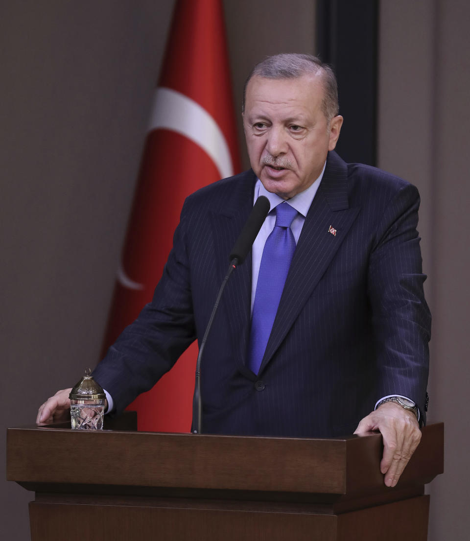 Turkish President Recep Tayyip Erdogan speaks to reporters before a visit to the United States, in Ankara, Turkey, Tuesday, Nov. 12, 2019. Erdogan warned European nations Tuesday that his country could release all the Islamic State group prisoners it holds and send them to Europe, in response to EU sanctions over Cyprus.(Presidential Press Service via AP, Pool)