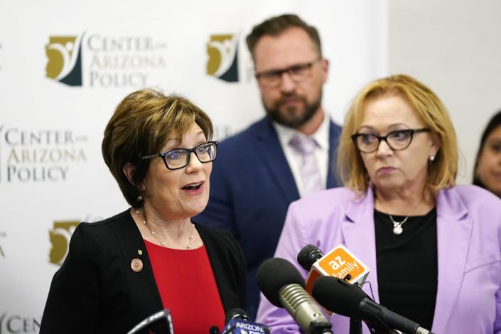 Arizona Sen. Nancy Barto, R-Phoenix, left, speaks during a news conference after the Supreme Court decision to overturn the landmark Roe v. Wade abortion decision as Center for Arizona Policy President Cathi Herrod Esq., right, and pregnancy resource centers representative Josh Chumley of Choices, middle, listen in Friday, June 24, 2022, in Phoenix. (AP Photo/Ross D. Franklin)