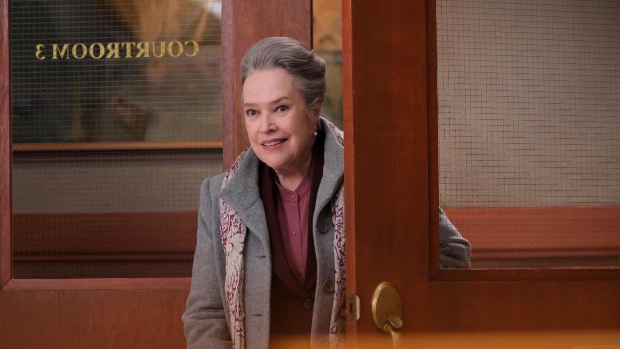  Kathy Bates as Madeline Matlock looking through a courtroom door in Matlock. 