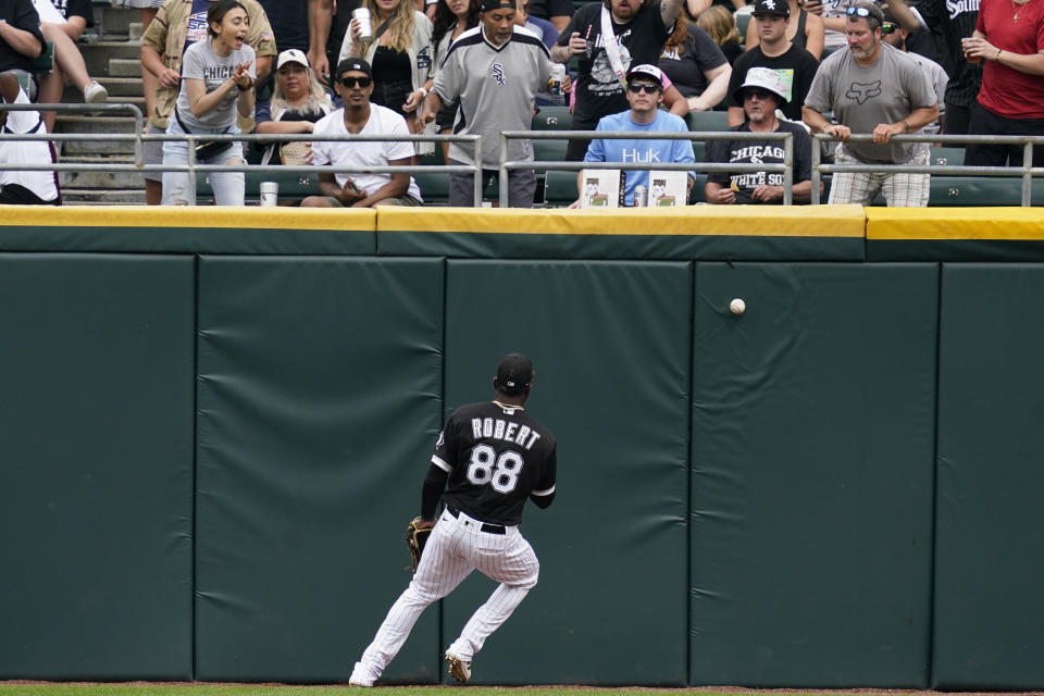 Chicago White Sox center fielder Luis Robert chases the ball on a three-run double hit by Baltimore Orioles' Austin Hays in the seventh inning of a baseball game in Chicago, Saturday, June 25, 2022. (AP Photo/Nam Y. Huh)