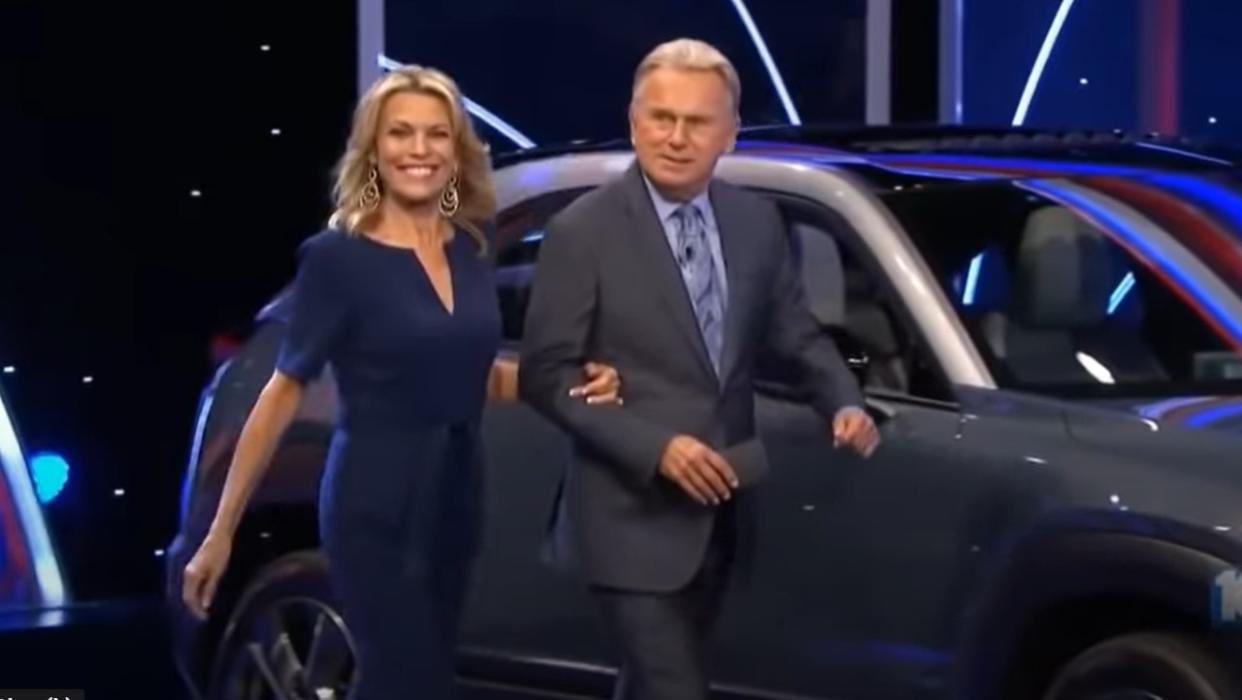  Vanna White and Pat Sajak take the stage on Wheel of Fortune. 