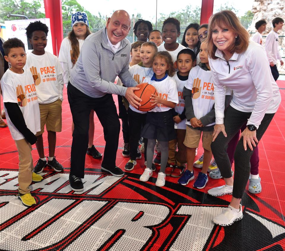 Dick Vitale and Nancy Lieberman pose for a photo with kids from the Boys & Girls Clubs of Sarasota and DeSoto Counties following the dedication of a Dream Court basketball court Thursday, named in honor of Vitale. The 84-year-old had surgery Thursday on his vocal cords at Massachusetts General Hospital.