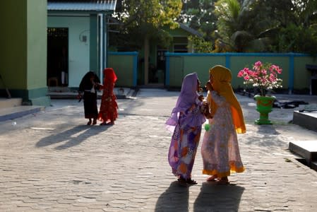 uslim children react as they play outside a mosque in North Penajam Paser regency