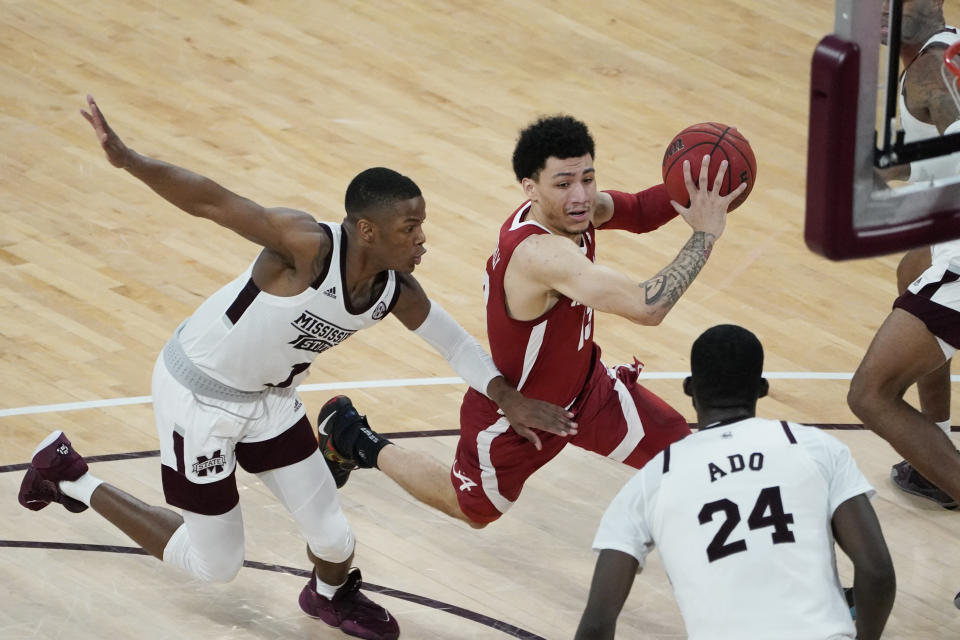 Alabama guard Jahvon Quinerly (13) dribbles past Mississippi State guard Iverson Molinar (1) during the second half of an NCAA college basketball game in Starkville, Miss., Saturday, Feb. 27, 2021. (AP Photo/Rogelio V. Solis)