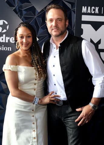 <p>Hubert Vestil/Getty</p> Tamera Mowry (Left) and Adam Housley in 2023