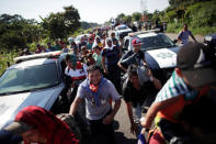 Central American migrants walk along the highway near the border with Guatemala, as they continue their journey trying to reach the U.S., in Tapachula, Mexico October 21, 2018. REUTERS/Ueslei Marcelino