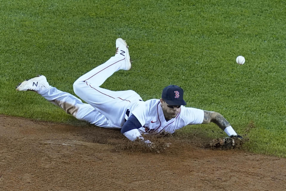 Boston Red Sox second baseman Michael Chavis cannot make a play on a single by New York Yankees' Gleyber Torres in the sixth inning of a baseball game at Fenway Park, Thursday, July 22, 2021, in Boston. (AP Photo/Elise Amendola)