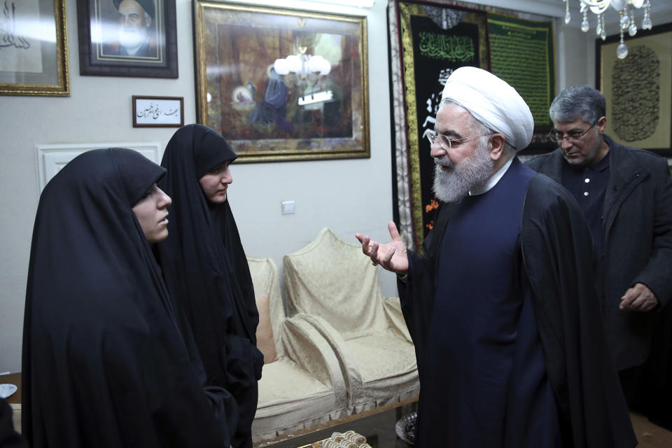 In this photo released by the official website of the office of the Iranian Presidency, President Hassan Rouhani, second right, meets family of Iranian Revolutionary Guard Gen. Qassem Soleimani, who was killed in the U.S. airstrike in Iraq, at his home in Tehran, Iran, Saturday, Jan. 4, 2020. (Iranian Presidency Office via AP)