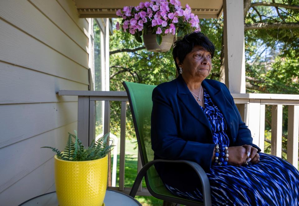 Lizzy Pugh, a 77-year-old Detroit Public Schools retiree, starts crying after recalling the memory of the bank refusing to deposit her casino winnings as she sits on the porch of her niece's home in West Bloomfield on Sept. 1, 2022.