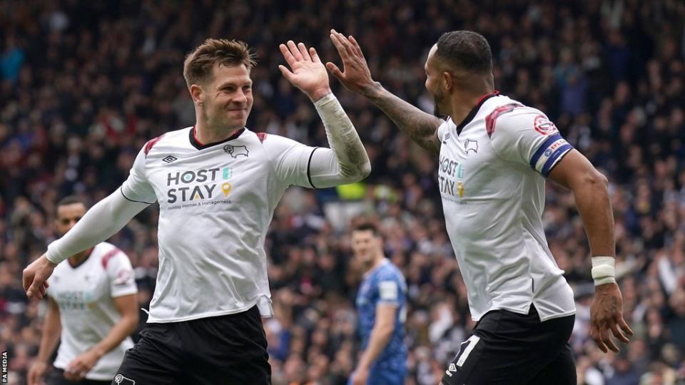 James Collins (left) high-fives Nathaniel Mendez-Laing after putting Derby 2-0 up against Carlisle