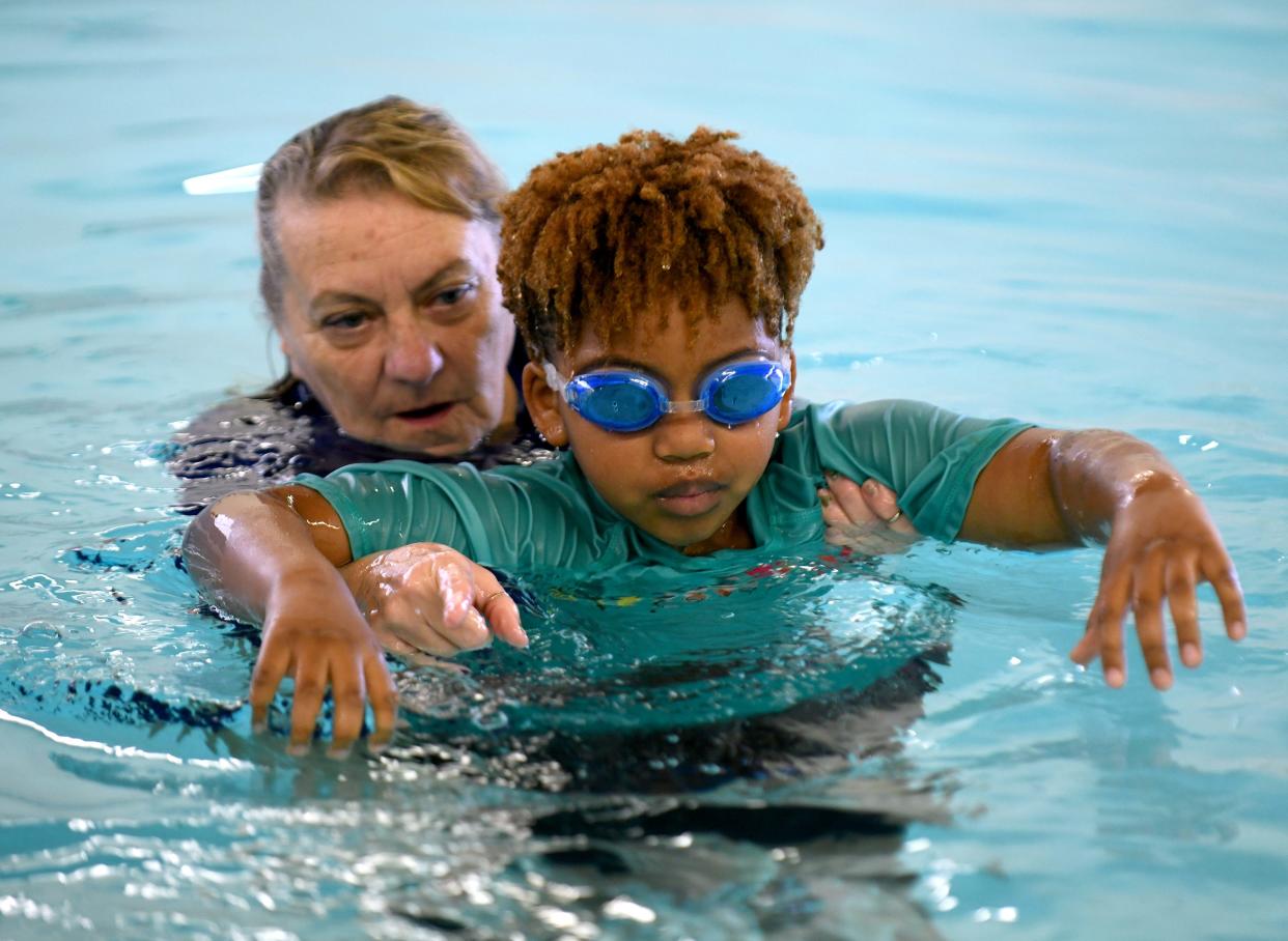 CJ Anderson, a first grade student at Frazer Elementary School, takes swim lessons with the help of instructor Glenda Lehmiller at the Eric Snow Family YMCA in Canton as part of a partnership between the YMCA and Plain Local Schools.