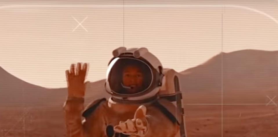 An artistic illustration of an astronaut on Mars waving at a camera.