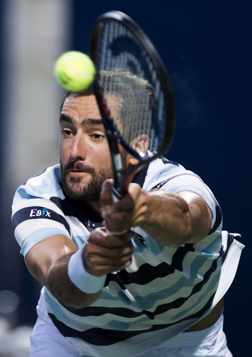 Marin Cilic, of Croatia, returns the ball against Rafael Nadal, of Spain, during quarterfinal men's Rogers Cup tennis action in Toronto, Friday, Aug. 10, 2018. (Nathan Denette/The Canadian Press via AP)