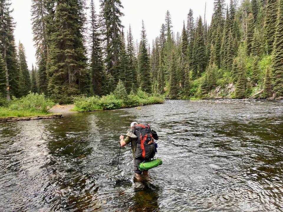 Idaho Capital Sun reporter Clark Corbin navigates a crossing of the Bechler River in Yellowstone National Park.