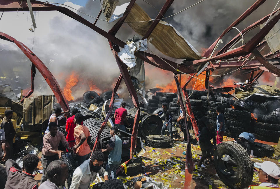 People sift through wreckage in the aftermath at the scene of an airstrike in Mekele, the capital of the Tigray region of northern Ethiopia Wednesday, Oct. 20, 2021. New airstrikes have hit Mekele, residents said Wednesday, as Ethiopia's government said it was targeting facilities to make and repair weapons, which a spokesman for the rival Tigray forces denied. (AP Photo)