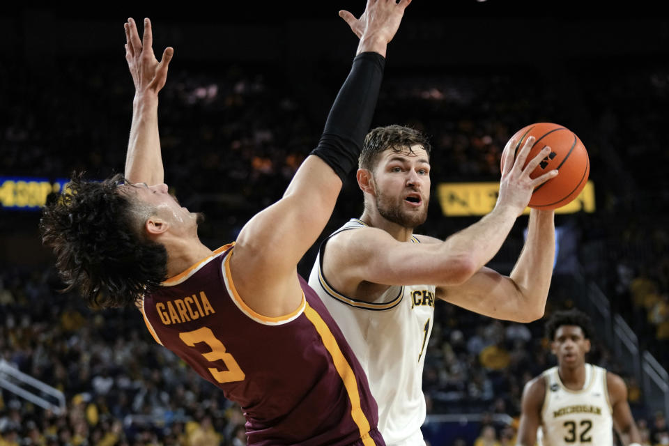 Michigan center Hunter Dickinson (1) drives on Minnesota forward Dawson Garcia (3) in the second half of an NCAA college basketball game in Ann Arbor, Mich., Sunday, Jan. 22, 2023. (AP Photo/Paul Sancya)