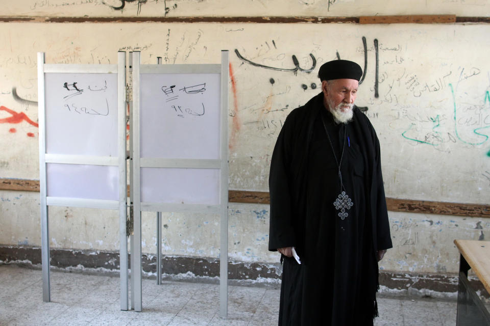 Father Antonious stands stands inside a polling station in Dalga village of Minya, Egypt, Wednesday, Jan. 15, 2014. He is one of the priests of the Virgin Mary and St. Abraam Monastery that was looted and burned by supporters of ousted Islamist President Mohammed Morsi in August. Through violence or intimidation, Islamists in villages like this one used violence or intimidation to stop Christians from voting "no" to a 2012 constitution that had paved the way for the creation of an Islamic state. This time around, no one is stopping the Christians and they are voting "yes" on a new charter that criminalizes discrimination and instructs the next legislature to ease restrictions on building churches. (AP Photo/Roger Anis, El Shorouk Newspaper) EGYPT OUT