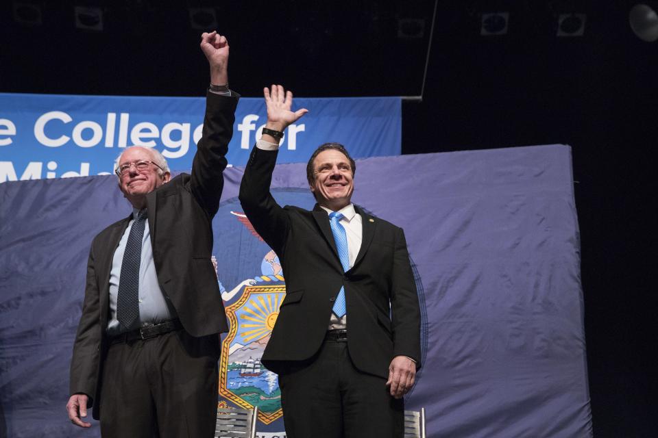 New York Gov. Andrew Cuomo, right, and Vermont Sen. Bernie Sanders arrive onstage at a Jan. 3 event at LaGuardia Community College, where Cuomo announced his free-tuition proposal.