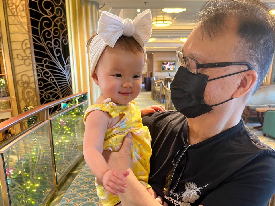 Tiffany Leigh's father holding her baby on Disney Fantasy cruise freelancer photo