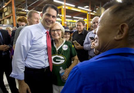 Republican presidential candidate Wisconsin Gov. Scott Walker (L) poses with Delores Lein of Hayward, Wisc. following a town hall meeting at the Xtreme Manufacturing warehouse in Las Vegas, Nevada September 14, 2015. REUTERS/Las VegasSun/Steve Marcus